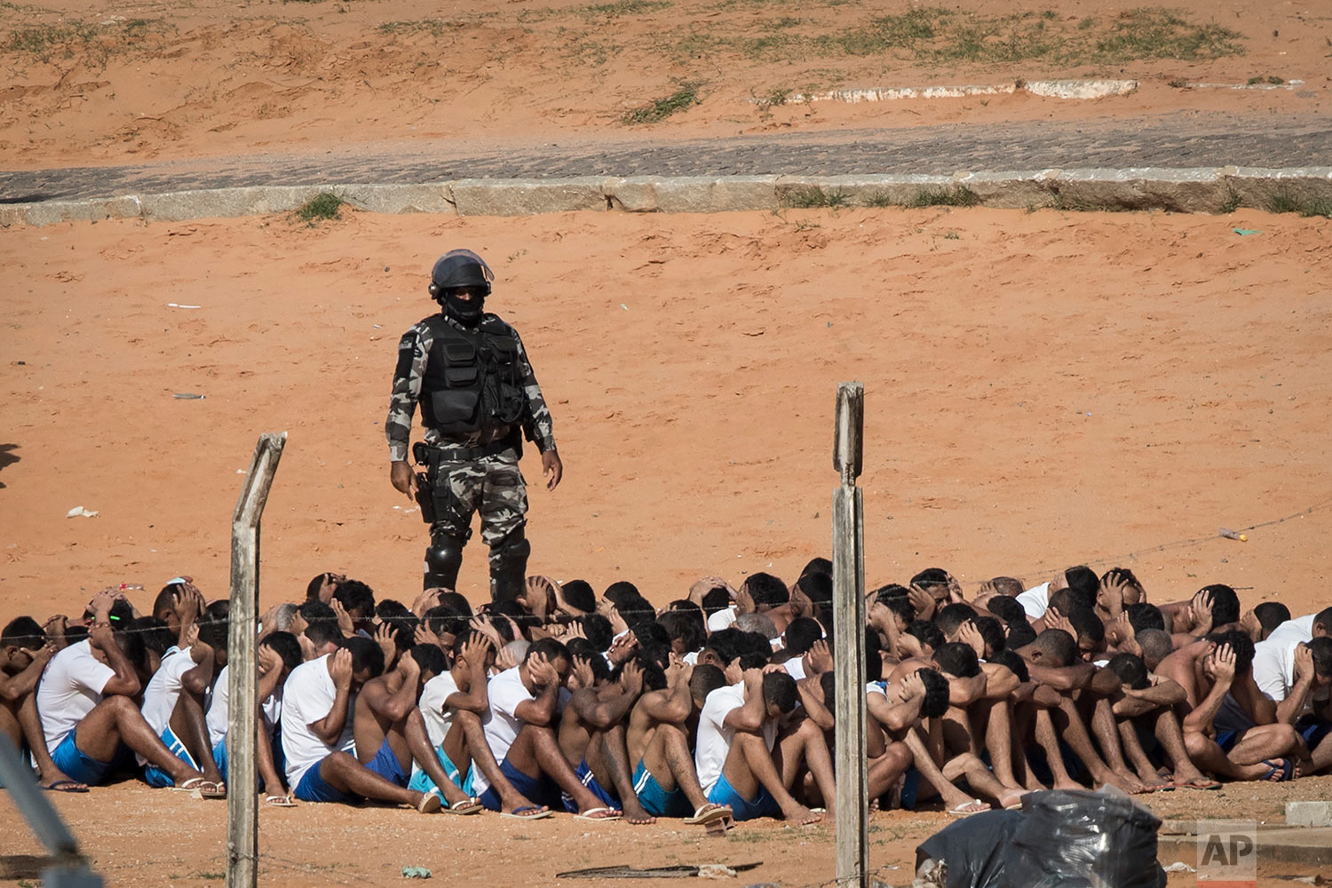 A military police officer conducts a head count of inmates at the Alcacuz prison in Nisia Floresta, Brazil, Tuesday, Jan. 24, 2017. Military police entered the prison in northeastern Brazil where a temporary wall separating two rival gangs was being built, after a week of chaos and fighting between rival gangs that left dozens of inmates dead. (AP Photo/Felipe Dana)