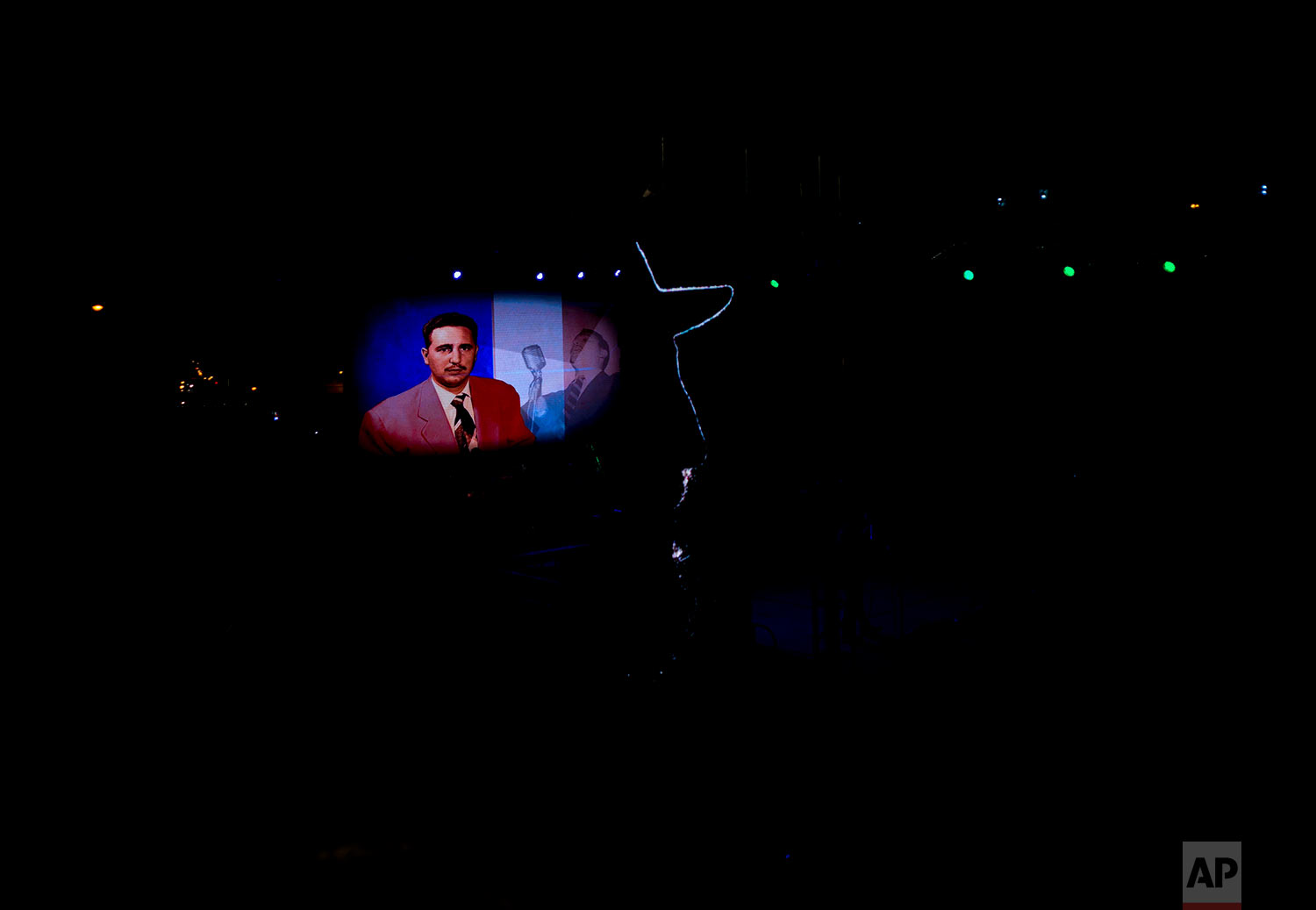 Images of Cuba's late leader Fidel Castro are projected on a screen during a vigil to commemorate the first anniversary of his death at the University of Havana, Cuba, Saturday, Nov. 25, 2017. Fidel Castro came to power through a 1959 revolution that overthrew Cuban dictator Fulgencio Batista. (AP Photo/Ramon Espinosa)