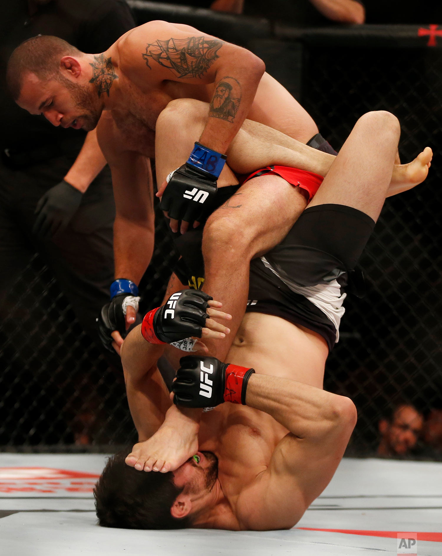 U.S.' Eric Spicely, top, fights Brazil's Antonio Carlos Junior during their UFC middleweight mixed martial arts bout in Rio de Janeiro, Brazil, Saturday, June 3, 2017. (AP Photo/Leo Correa)