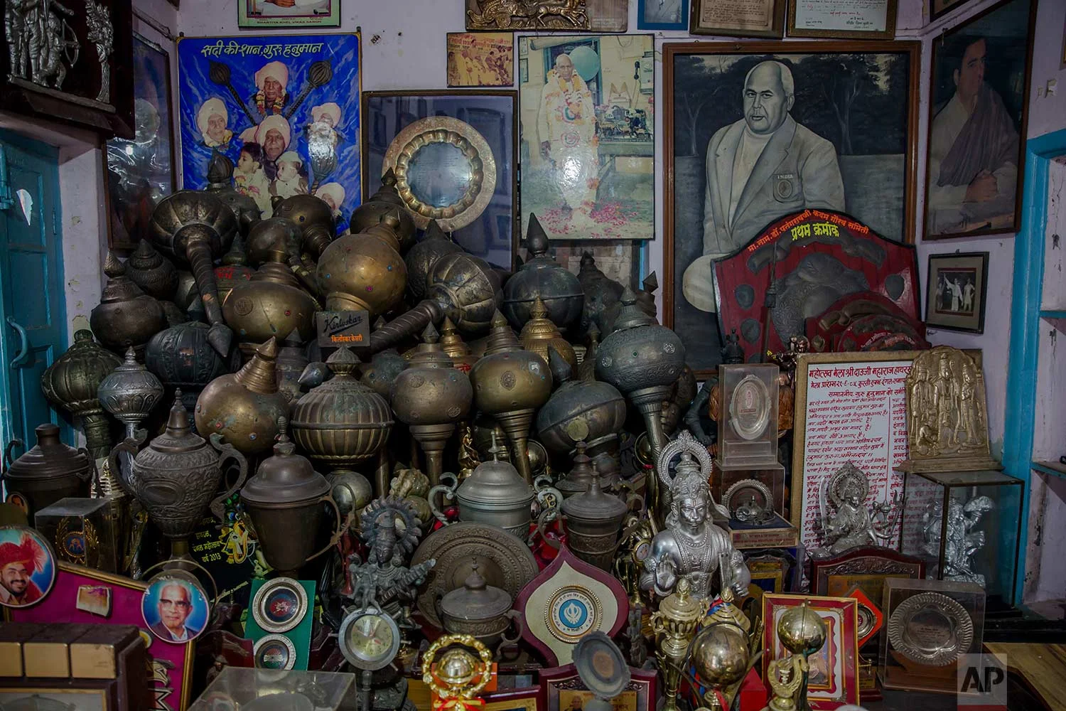 In this Nov. 20, 2017 photo, photographs and trophies belonging to Indian Kushti wrestlers are seen inside the office of Guru Hunuman Akhada, one of India's oldest akhadas at Sabzi Mandi, in New Delhi, India. (AP Photo/Dar Yasin)