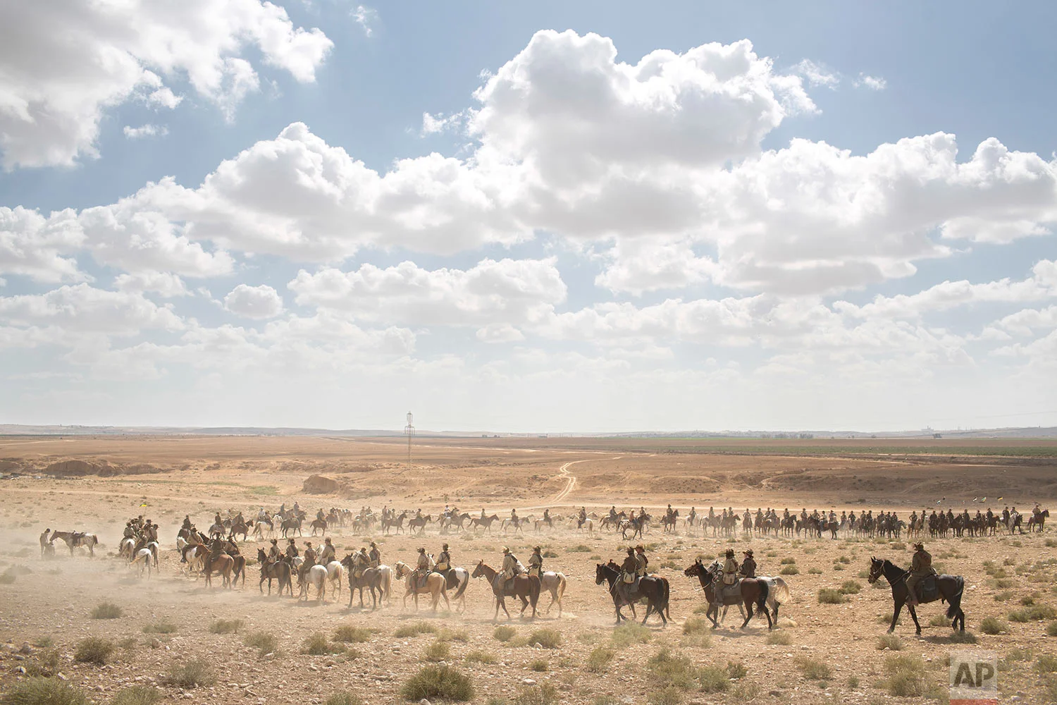 History enthusiasts and descendants of Australian Mounted Division and ANZAC (Australian and New Zealand Mounted Division) Mounted Division soldiers ride their horses during the reenactment of the Battle of Beersheba when British and ANZAC forces captured Beersheba from the Ottoman Empire during the World War I, as part of the 100 years anniversary in near Beersheba, southern Israel, Monday, Oct. 30, 2017. (AP Photo/Oded Balilty)