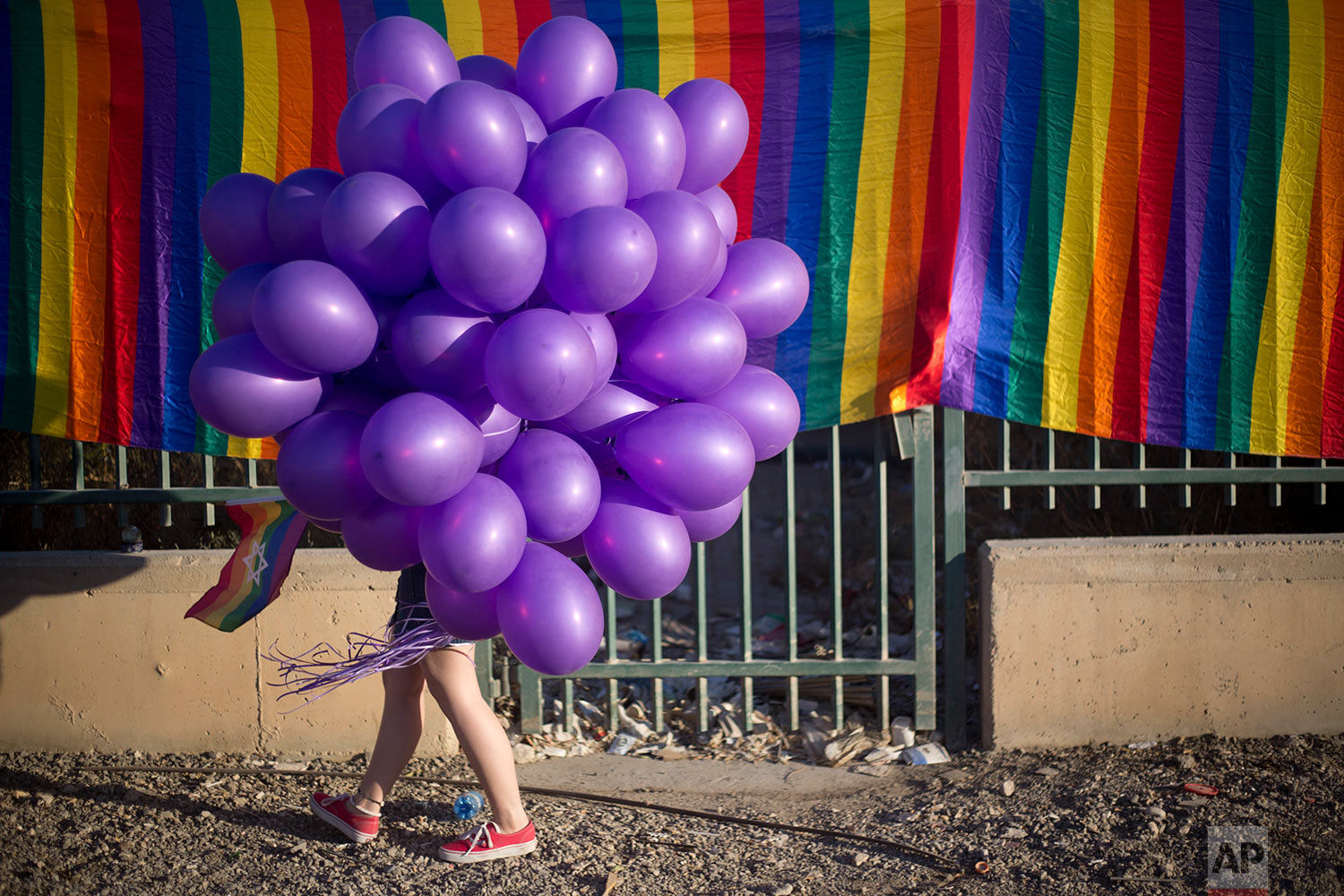 A woman holds balloons as she participates in the first Gay Pride Parade in Beersheba, Israel, Thursday, June 22, 2017. (AP Photo/Ariel Schalit)