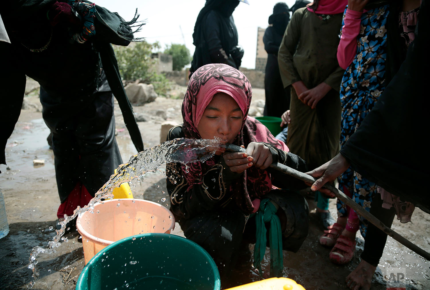 A girl drinks water from a well that alleged to be contaminated water with the bacterium Vibrio cholera, on the outskirts of Sanaa, Yemen on July 12, 2017. Yemen’s raging two-year conflict has served as an incubator for lethal cholera. (AP Photo/Hani Mohammed)