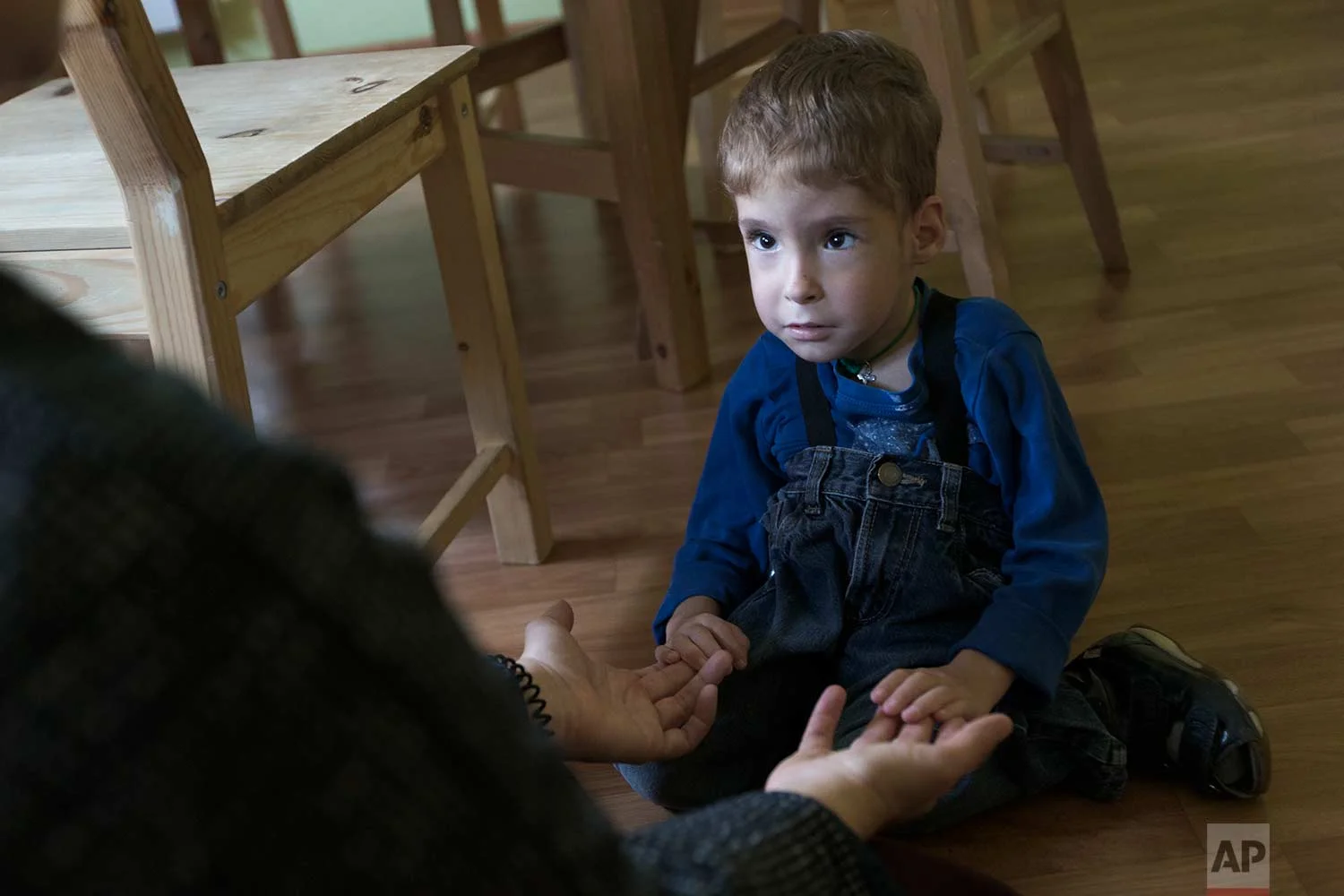 Volunteer Yelizaveta, left, looks at 4-year-old pupil, Syoma, at the St. Sophia orphanage in Moscow, Russia, on Tuesday, Sept. 12, 2017. (AP Photo/Ivan Sekretarev)