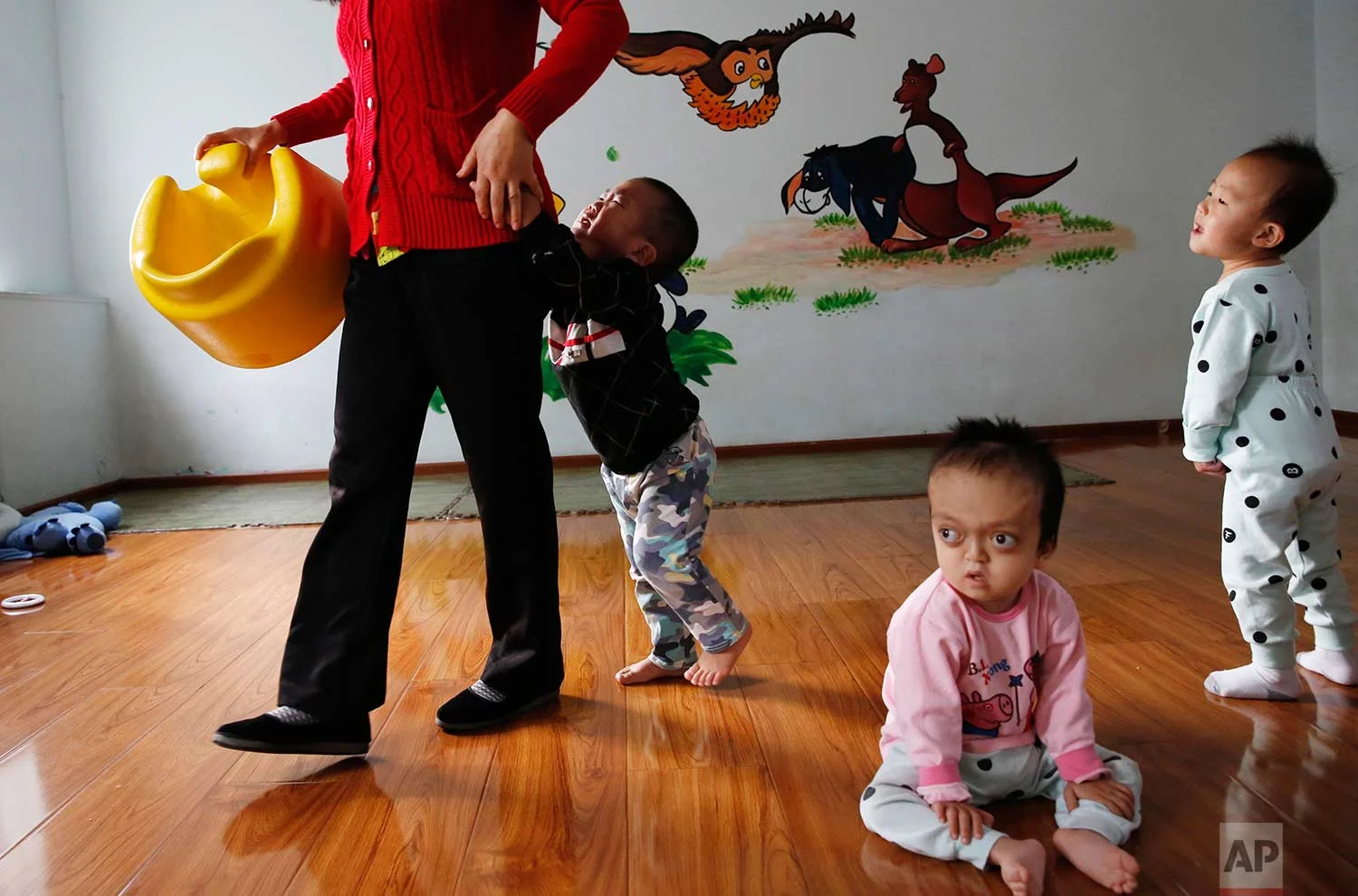 Children rest and play at a foster home of the New Hope Foundation on the outskirts of Beijing, China, on Wednesday, Oct. 11, 2017. (AP Photo/Ng Han Guan)