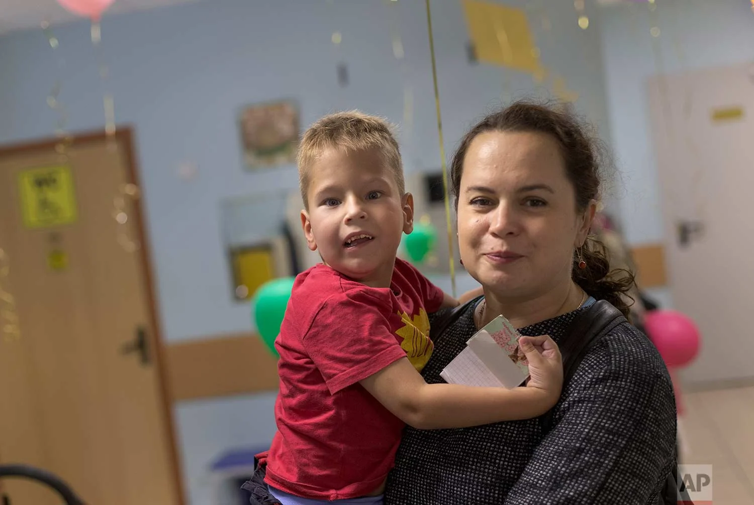 Volunteer Yelizaveta and 6-year-old former pupil, Kostya, arrive to the St. Sophia's orphanage in Moscow, Russia, on Tuesday, Sept. 12, 2017. (AP Photo/Ivan Sekretarev)