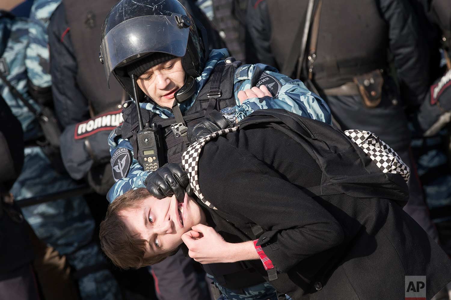  In this Sunday, March 26, 2017 photo, police detain a protester in downtown Moscow, Russia. Thousands of people crowded into Moscow's Pushkin Square on Sunday for an unsanctioned protest against the Russian government, the biggest gathering in a wav