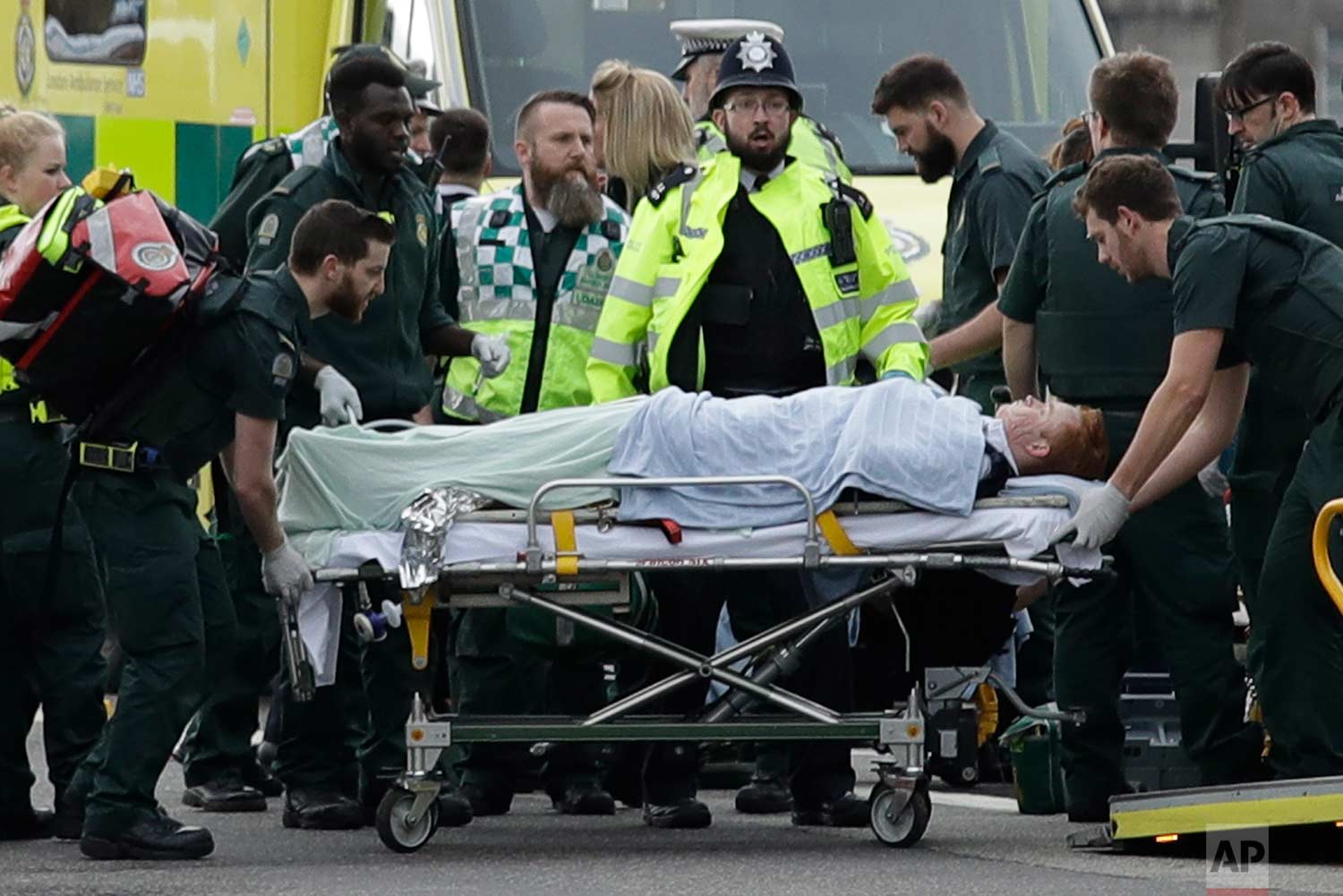  In this Wednesday, March 22, 2017 photo, emergency services staff provide medical attention to injured people on Westminster Bridge, near the Houses of Parliament in London. The Islamic State group claimed responsibility for the attack by a man who 