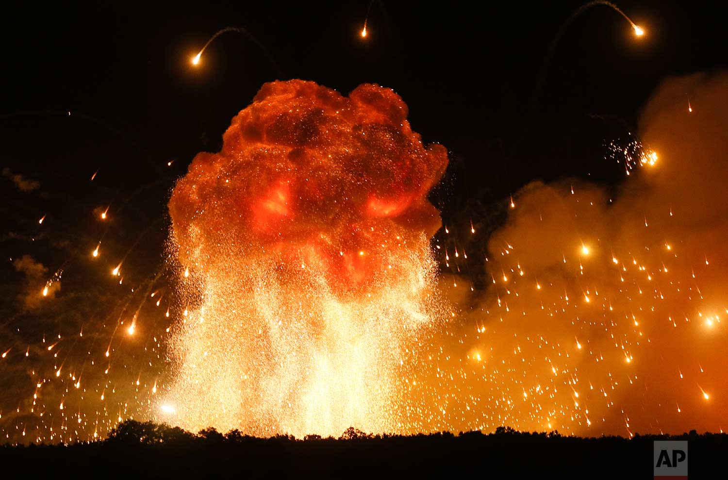  In this Wednesday, Sept. 27, 2017 photo, a powerful explosion is seen in the ammunition depot at a military base in Kalynivka, west of Kiev, Ukraine.  Ukrainian officials say they have evacuated more than 30,000 people after a fire and ammunition ex