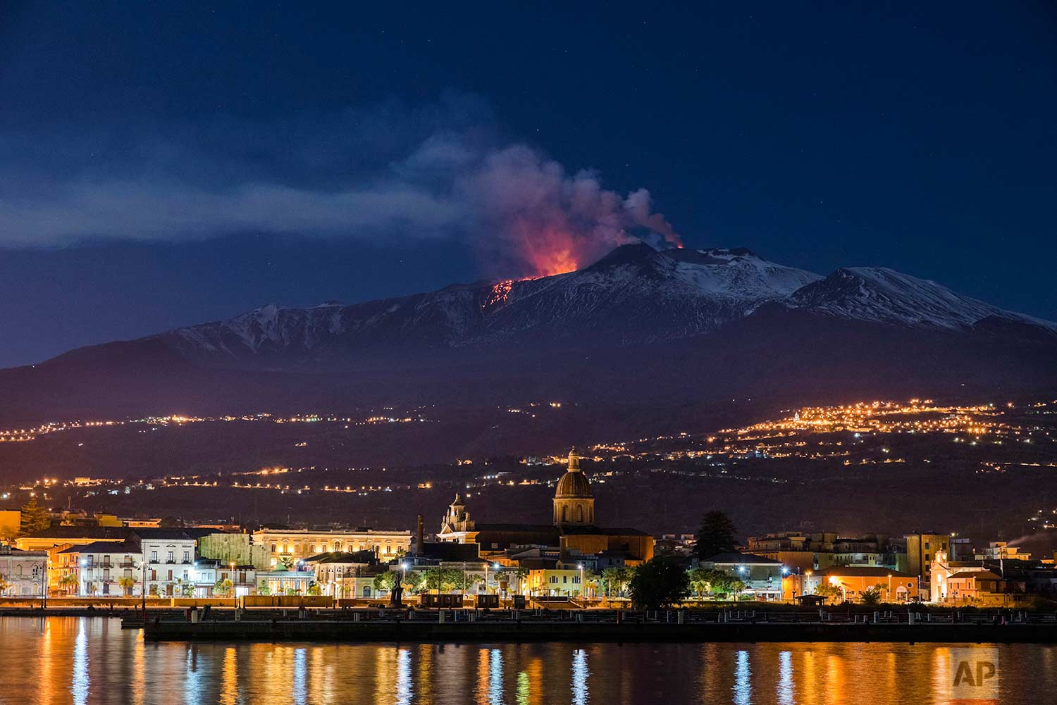  In this Tuesday, April 11, 2017 photo, Mount Etna, Europe's most active volcano, spews lava as the Sicilian town of Riposto, Italy, is visible in foreground, during an eruption. (AP Photo/Salvatore Allegra) 