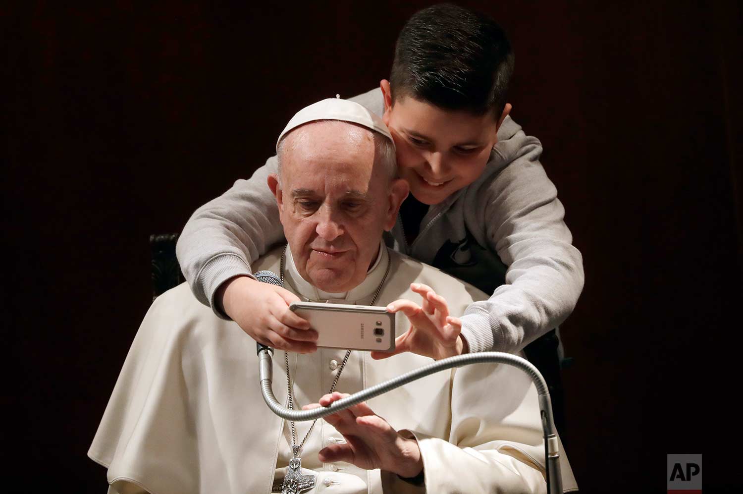  In this Sunday, Feb. 19, 2017 photo, a boy takes a selfie with Pope Francis, during a visit to the parish of Santa Maria Josefa del Cuore di Gesu', in Rome. (AP Photo/Alessandra Tarantino) 
