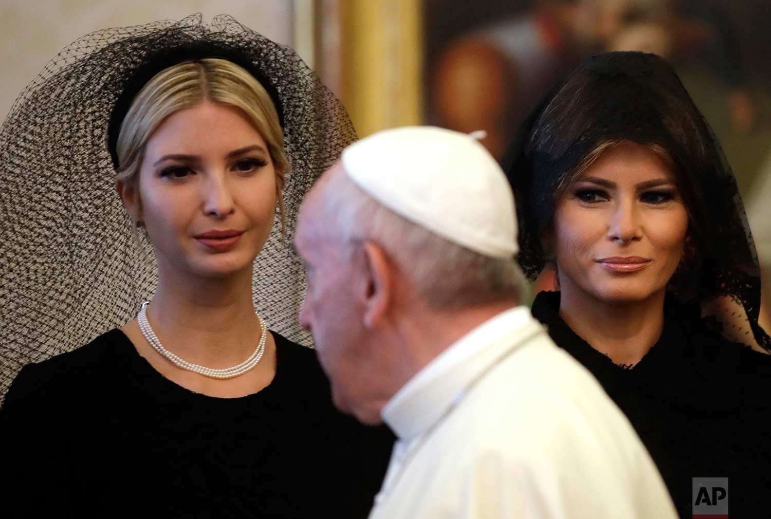  In this Wednesday, May 24, 2017 photo, Pope Francis walks past Ivanka Trump, left, and First Lady Melania Trump on the occasion of the private audience with President Donald Trump, at the Vatican. (AP Photo/Alessandra Tarantino) 