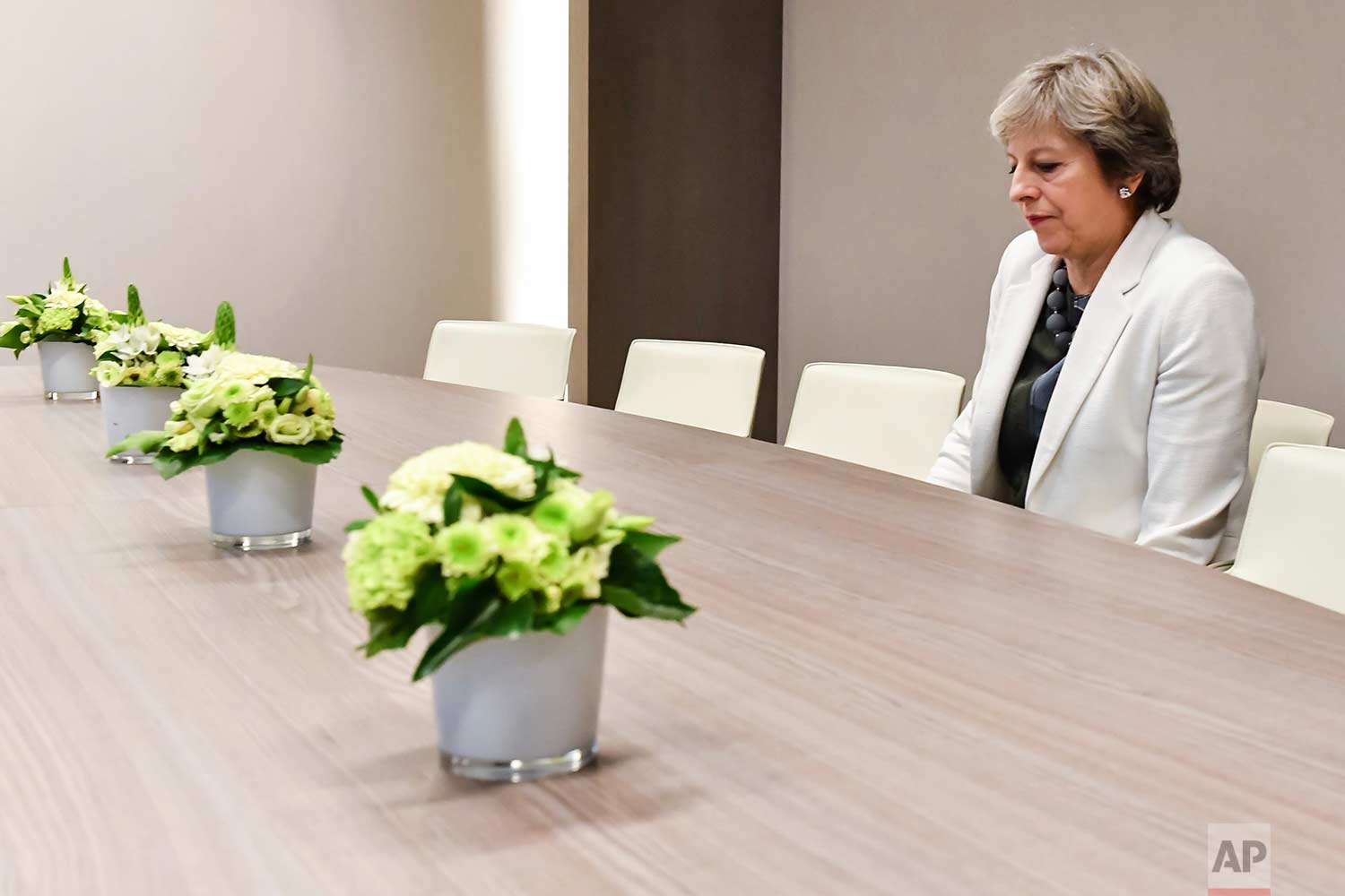  In this Friday, Oct. 20, 2017 photo, British Prime Minister Theresa May waits for the arrival of European Council President Donald Tusk prior to a bilateral meeting with European Council President Donald Tusk during an EU summit in Brussels. Europea
