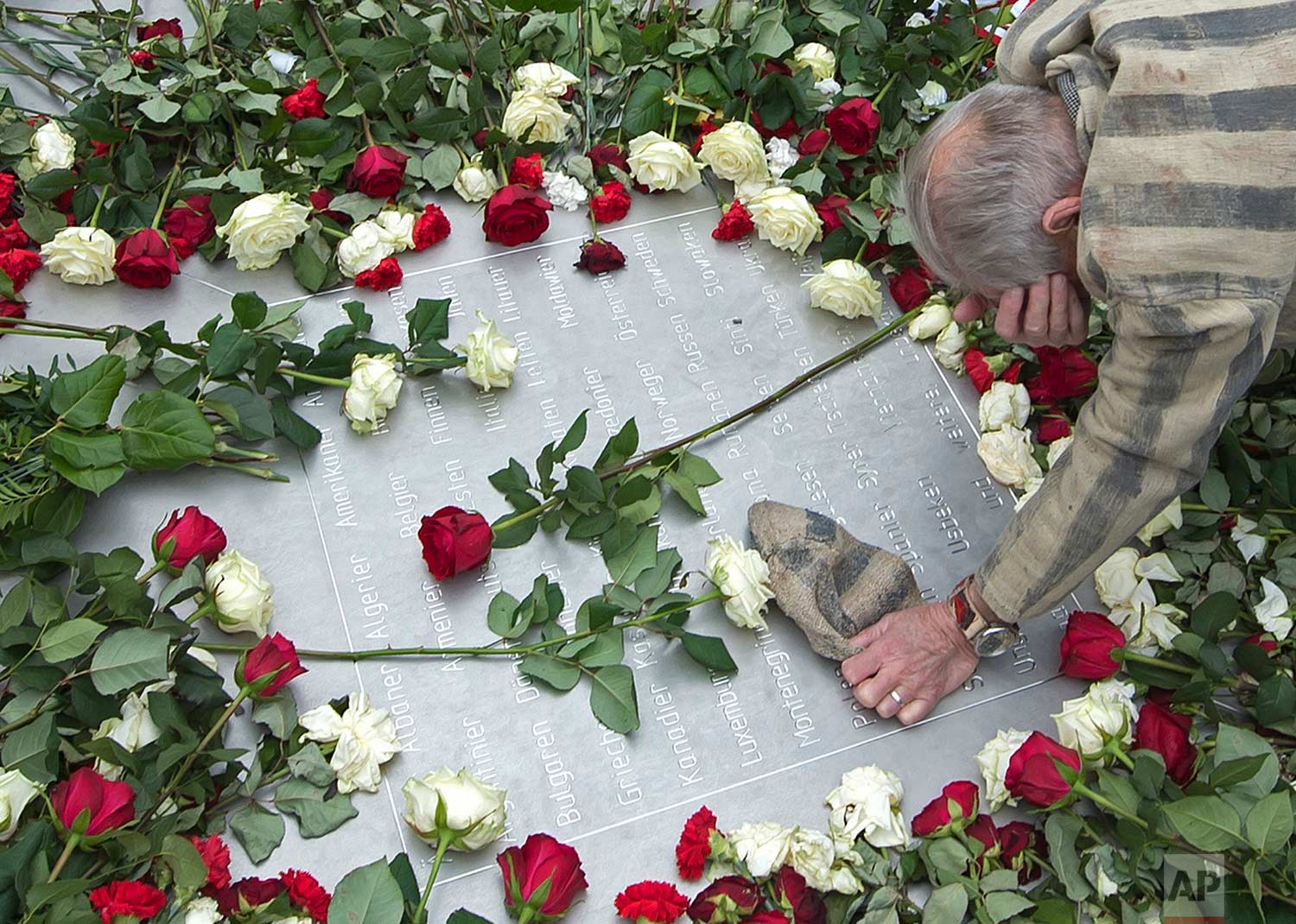  In this Tuesday, April 11, 2017 photo, Nazi concentration camp survivor Alexander Bytschok of Kiev, Ukraine, mourns on a metal plaque during the commemoration ceremonies for the 72th anniversary of the liberation of the former Nazi concentration cam