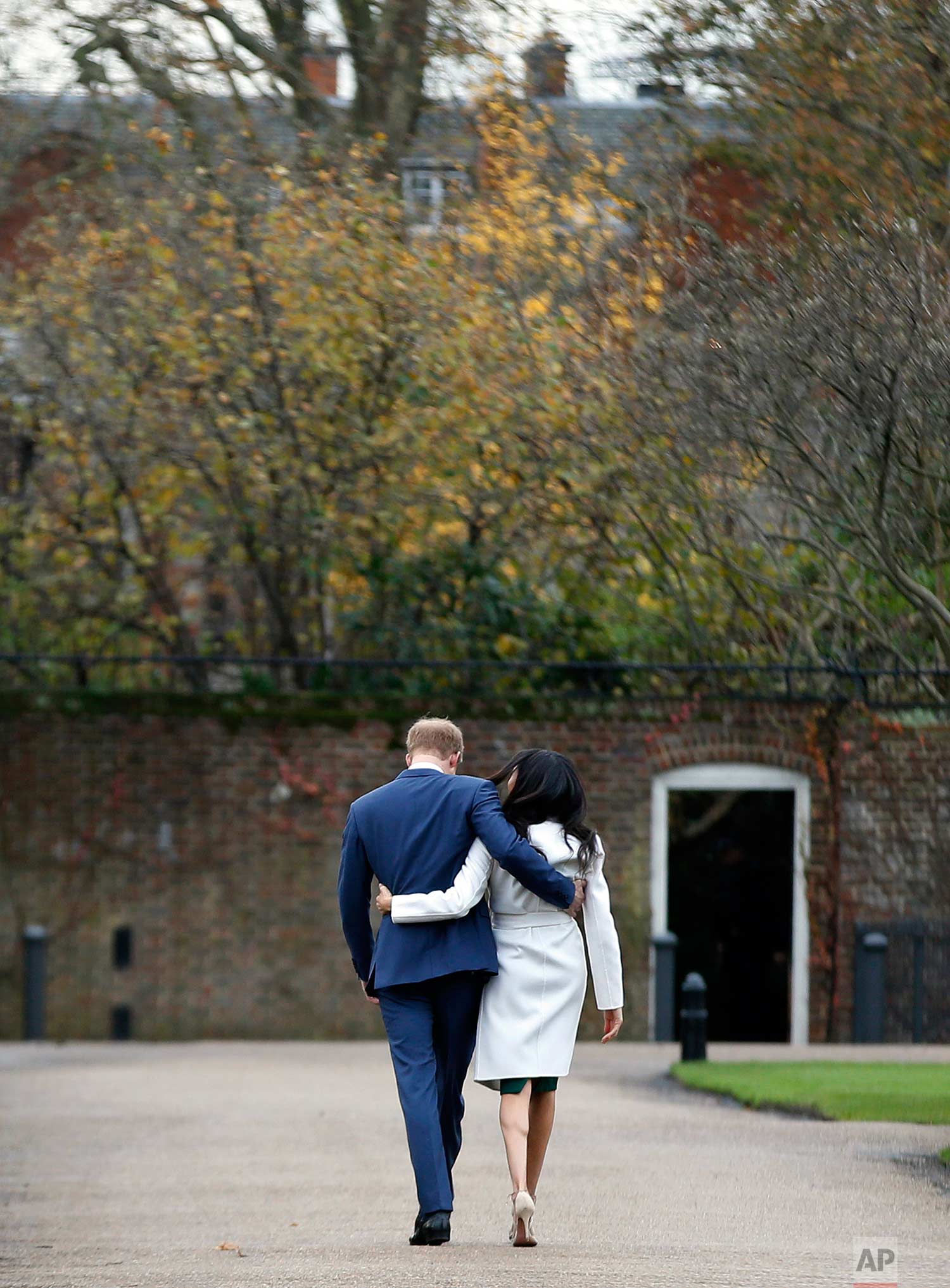 In this Monday Nov. 27, 2017 photo, Britain's Prince Harry and Meghan Markle walk away after posing for the media in the grounds of Kensington Palace in London. It was announced Monday that Prince Harry, fifth in line for the British throne, will ma