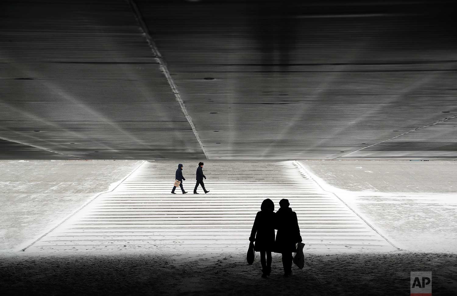  In this Wednesday, Jan. 25, 2017 photo, people walk through an underpass in Astana, Kazakhstan. The Kazakh capital was hit by a heavy gale and a snowfall with a temperature of - 6 C (F 21). (AP Photo/Sergei Grits) 