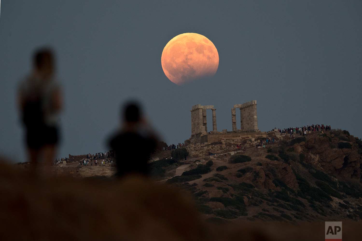  In this Monday, Aug. 7, 2017 photo, the August full moon rises above the 5th Century BC Temple of Poseidon at Cape Sounio, south of Athens. More than a hundred of Greece’s ancient sites - but not the Acropolis in Athens - and museums were kept open 