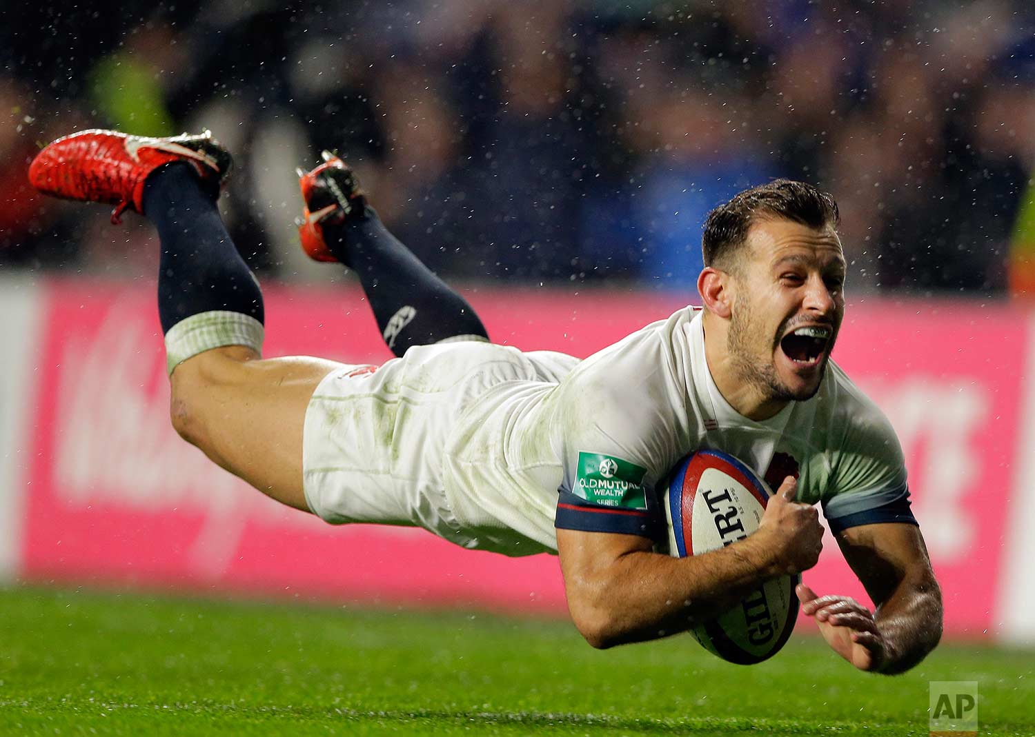 In this Saturday, Nov. 18, 2017 photo, England's Danny Care smiles as he goes over the line for England's fourth try during their rugby union international match between England and Australia at Twickenham stadium in London. (AP Photo/Alastair Grant