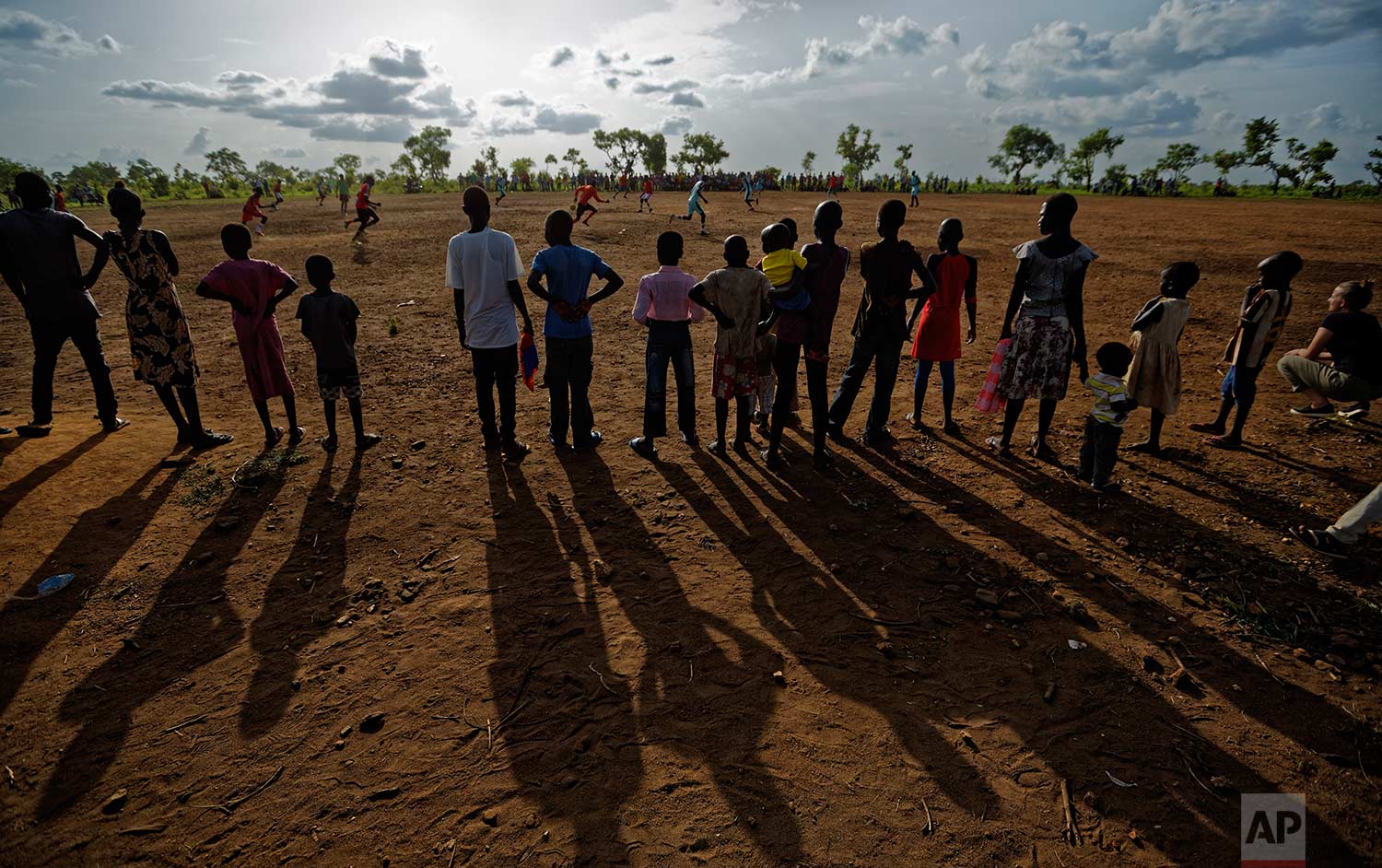  In this photo taken Sunday, June 4, 2017, South Sudanese refugees watch a match between refugee men's soccer teams, in the Bidi Bidi refugee settlement in northern Uganda. Soccer fields and inter-village competitions are found across the world's lar
