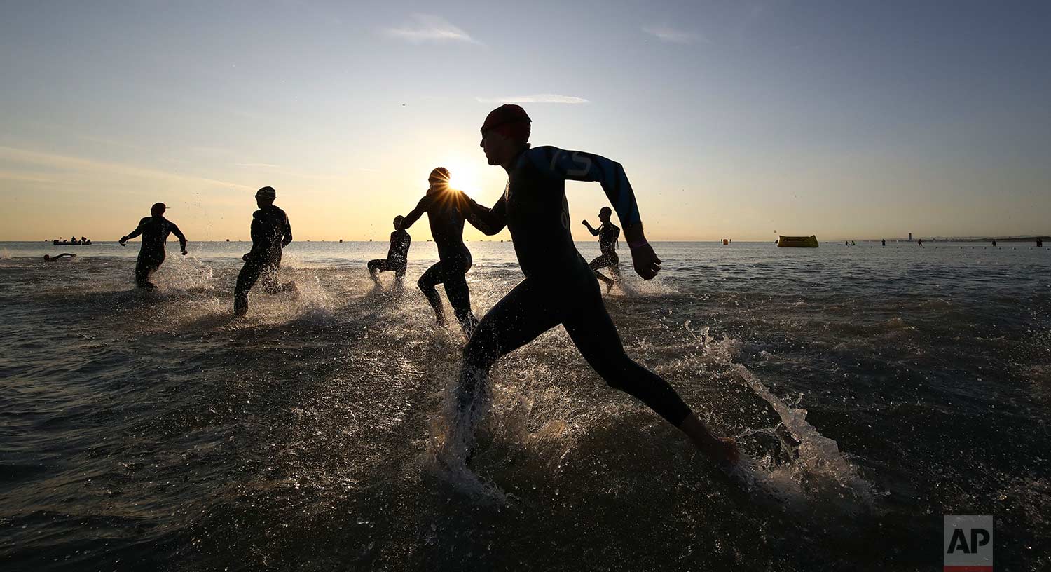  In this Saturday. Sept. 23, 2017 photo, athletes take the start of the swimming portion of an Ironman Triathlon competition, in Cervia, northern Italy. (AP Photo/Alessandro Trovati) 