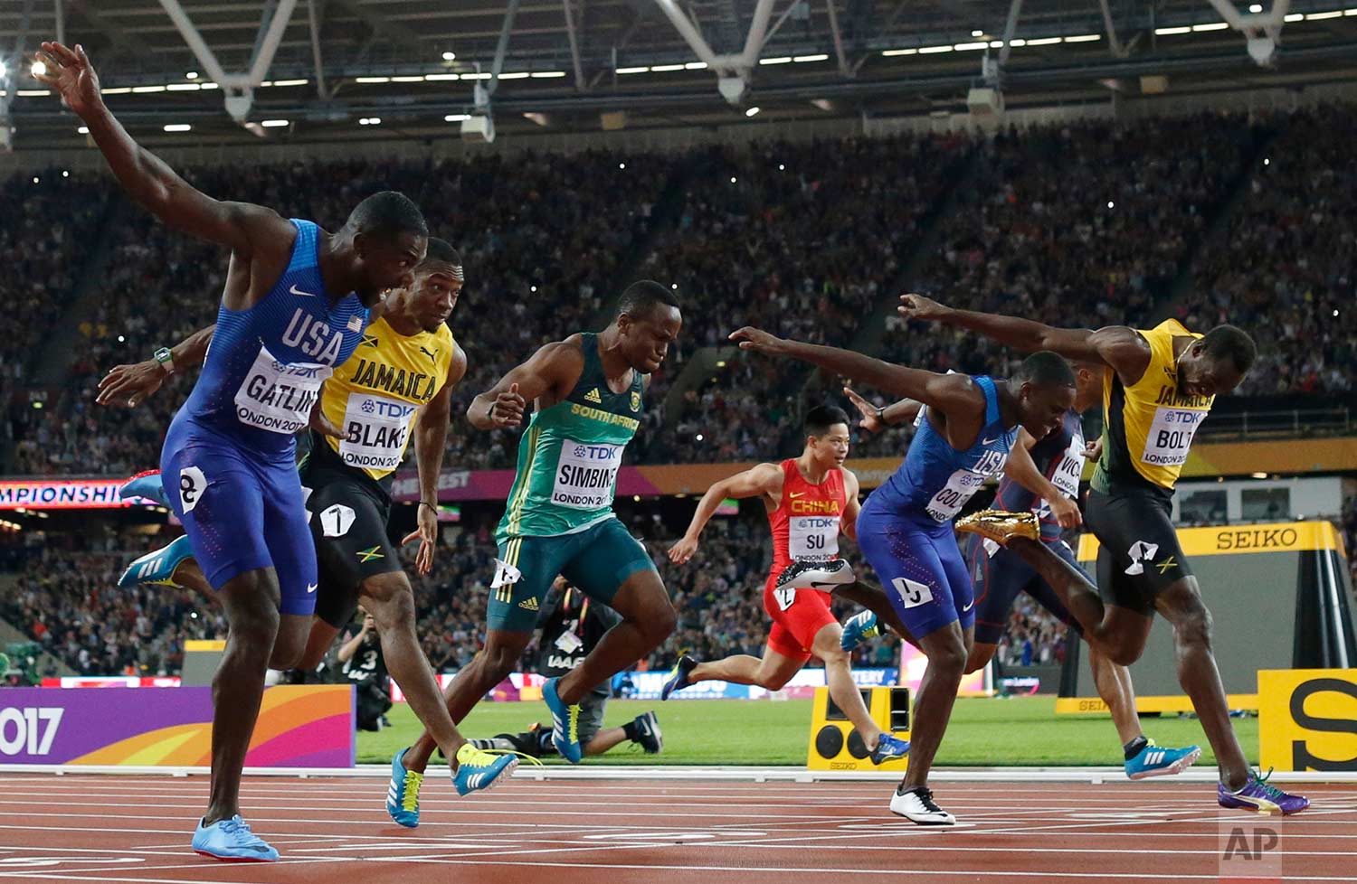  In this Saturday, Aug. 5, 2017 photo, United States' Justin Gatlin, left, crosses the line to win gold ahead of silver medal winner United States' Christian Coleman, second right, and bronze medal winner Jamaica's Usain Bolt, right, in the men's 100