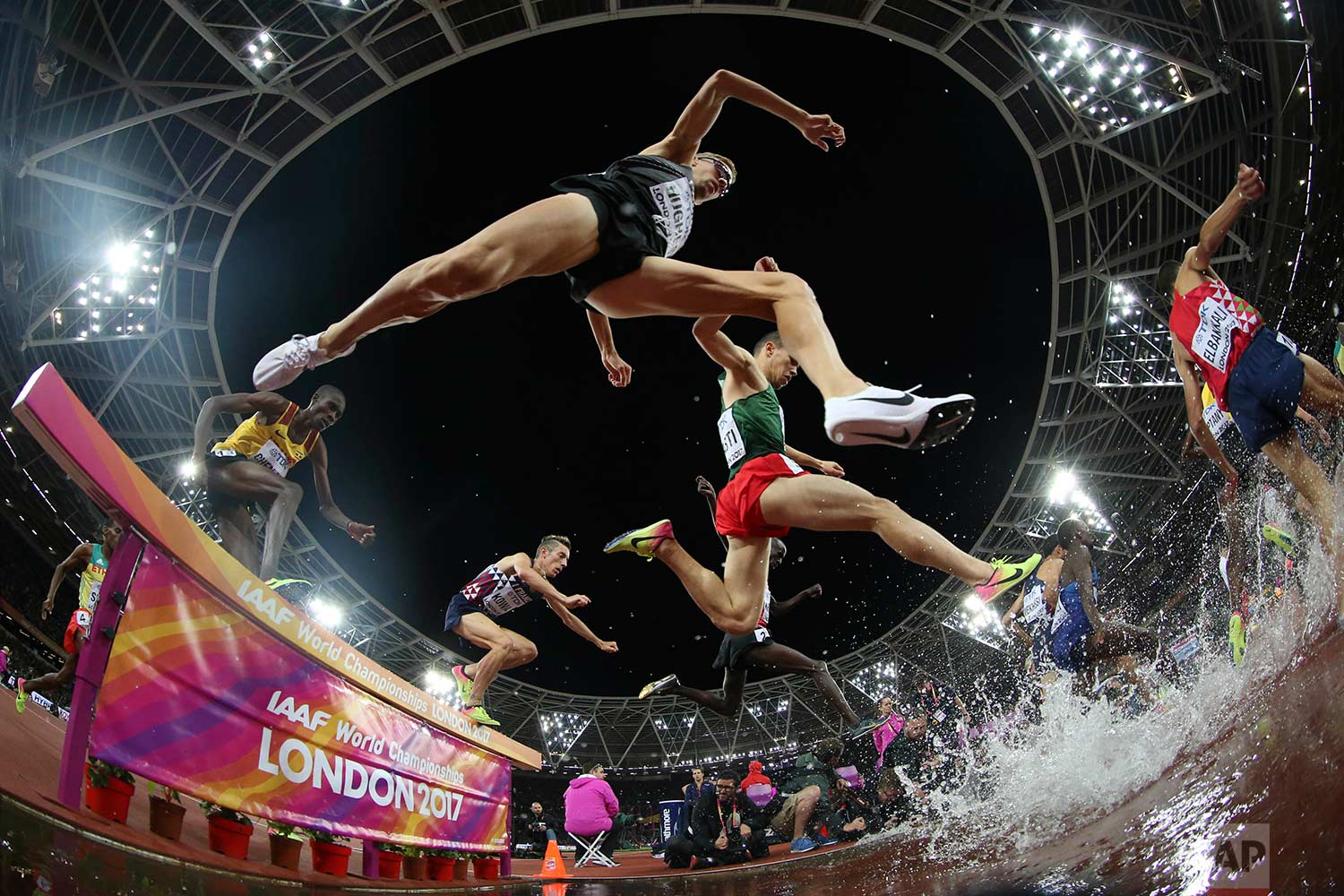  In this Tuesday, Aug. 8, 2017 photo, athletes compete in the men's 3000-meter steeplechase final during the World Athletics Championships in London. (AP Photo/Matthias Schrader) 