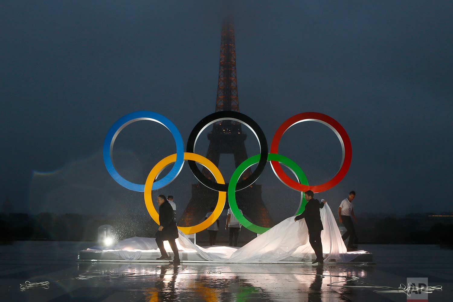  In this Wednesday, Sept. 13, 2017 photo, Paris officials unveil a display of the Olympic rings on Trocadero plaza that overlooks the Eiffel Tower, after the vote in Lima, Peru, awarding the 2024 Games to the French capital, in Paris, France. Paris w