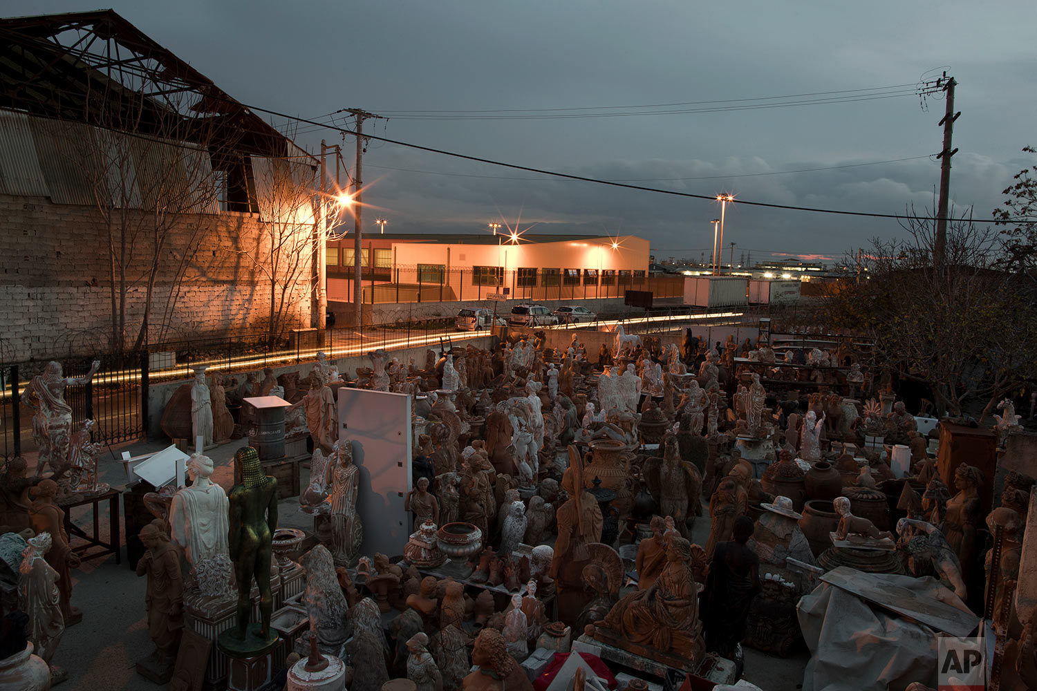  In this Tuesday Dec. 19, 2017 photo, terracotta statues, busts, antefixes and flower pots stands in the yard of Haralambos Goumas' sculpture and ceramic workshop, in the Egaleo suburb of Athens. (AP Photo/Petros Giannakouris) 