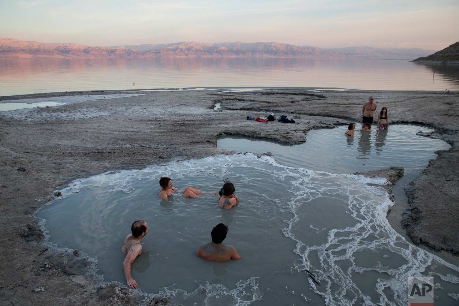  In this Friday, Nov. 24, 2017 photo, people enjoy a spring water pool along the Dead Sea shore near the Israeli Kibbutz of Ein Gedi. (AP Photo/Oded Balilty) 