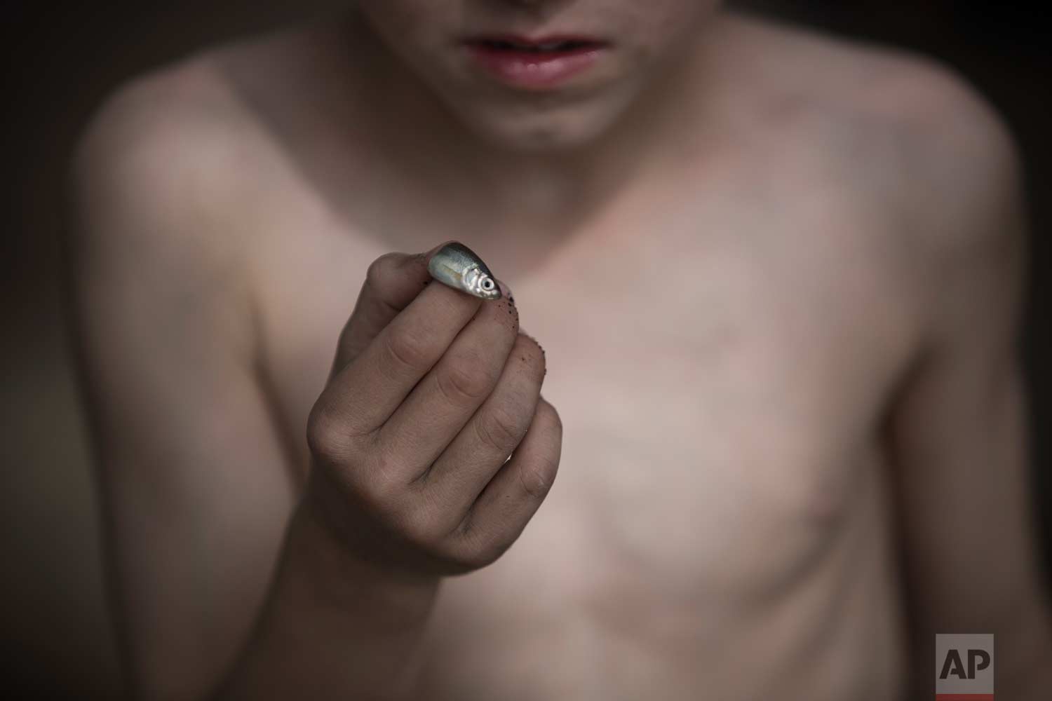  In this Tuesday, April. 11, 2017 photo, an Israeli youth shows off the small fish he caught on the banks of the Jordan River near the northern Israeli Kibbutz of Kinneret. (AP Photo/Oded Balilty) 