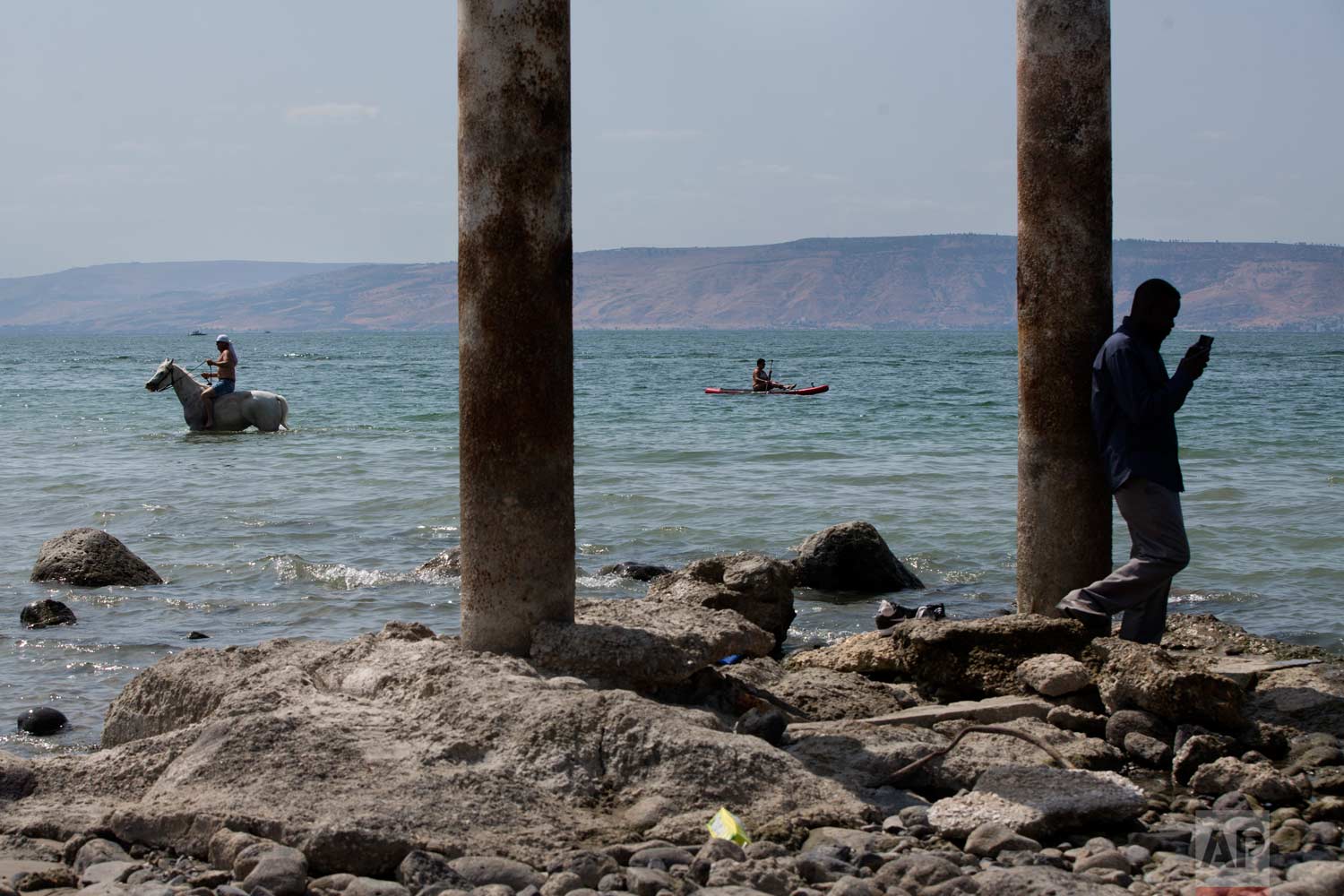  In this Sept. 23, 2017 photo, people enjoy the Sea of Galilee near the northern Israeli Kibbutz of Ein Gev. (AP Photo/Oded Balilty) 