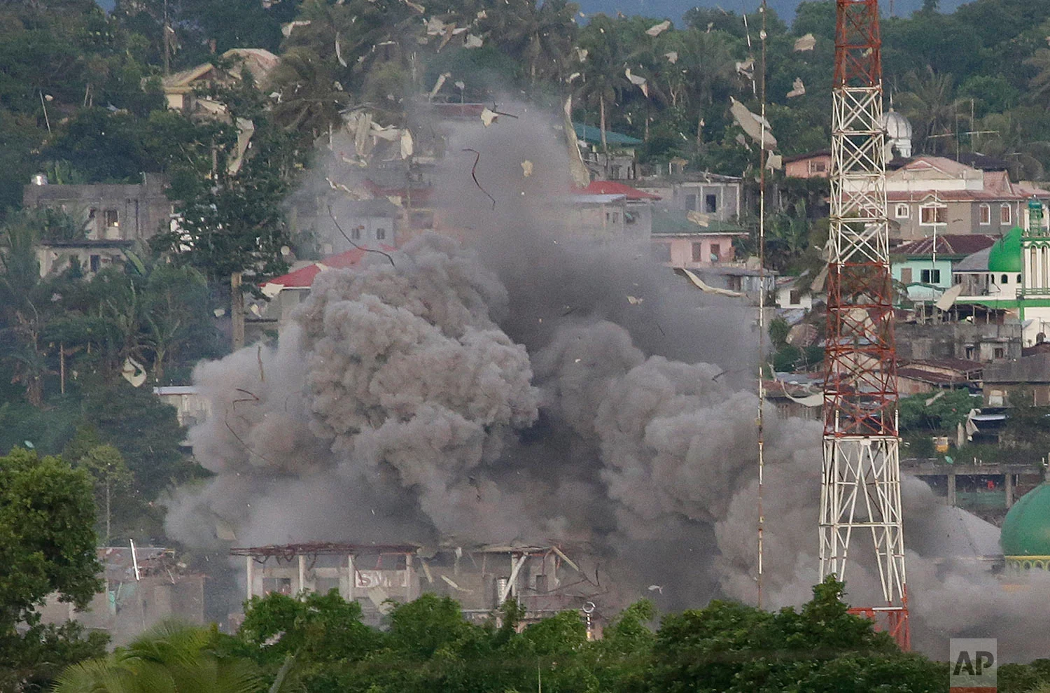 Debris fly as Philippine Air Force fighter jets bomb suspected positions of Muslim militants as fighting continues in Marawi city, southern Philippines Friday, June 9, 2017. It’s unclear how many people remain trapped in Marawi as government troops battle Muslim militants led by the so-called "Maute" group but army officers have put the figure this week at anywhere from 150 to 1,000. (AP Photo/Aaron Favila)