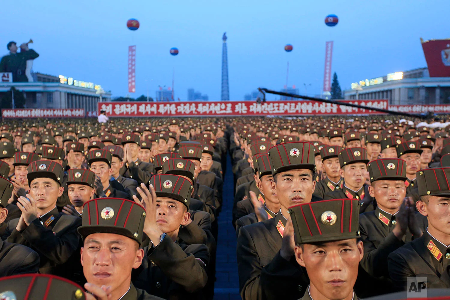 In this Thursday, July 6, 2017, file photo, soldiers gather in Kim Il Sung Square in Pyongyang, North Korea, to celebrate the test launch of North Korea's first intercontinental ballistic missile two days earlier. Threatening to fire a volley of missiles toward a major U.S. military hub _ and the home to 160,000 American civilians _ may seem like a pretty bad move for a country that is seriously outgunned and has an awful lot to lose. But pushing the envelope, or just threatening to do so, is what North Korea does best. (AP Photo/Jon Chol Jin, File)