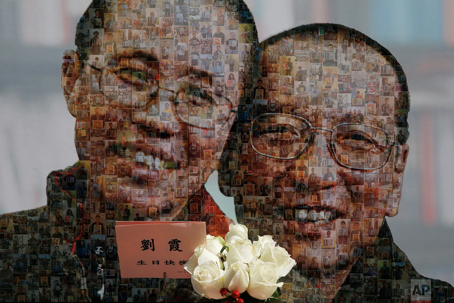 A poster featuring a image of jailed Chinese Nobel Peace laureate Liu Xiaobo and his detained wife Liu Xia, which is composed by photos of their supporters are displayed during a demonstration in Hong Kong, Saturday, April 1, 2017 as they send a blessings for Liu Xia's birthday. The protesters demanded to release Liu Xiaobo and Liu Xia. (AP Photo/Kin Cheung)