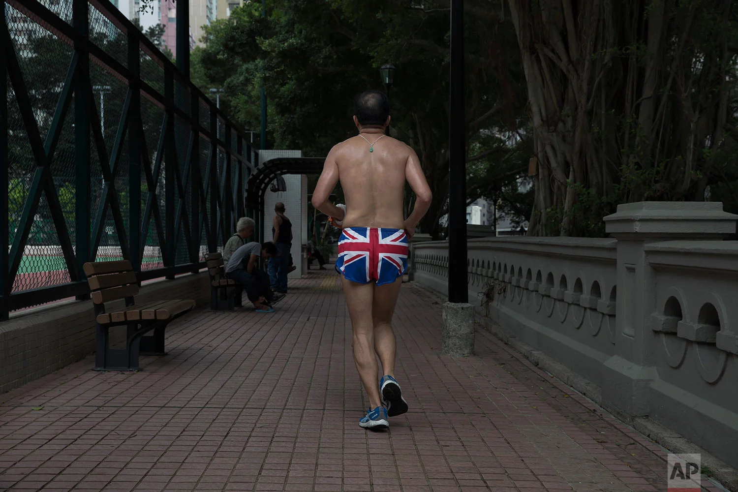 A man wearing the British flag shorts jogs at King George V Memorial Park in Hong Kong on Friday, June 2, 2017. Two decades after Hong Kong was handed to China, many residents continue to live their lives as before, holding onto old habits and routines as well as beliefs inspired by the former British colonial rulers, such as democracy, freedom of speech and justice. (AP Photo/Kin Cheung)