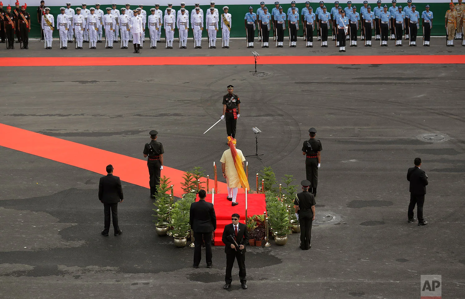 Indian Prime Minister Narendra Modi inspects a guard of honor before addressing the nation from the ramparts of Red Fort to celebrate Independence Day in New Delhi, India, Tuesday, Aug. 15, 2017. India commemorated its Independence in 1947 from British colonial rule, on Tuesday. (AP Photo/Manish Swarup)