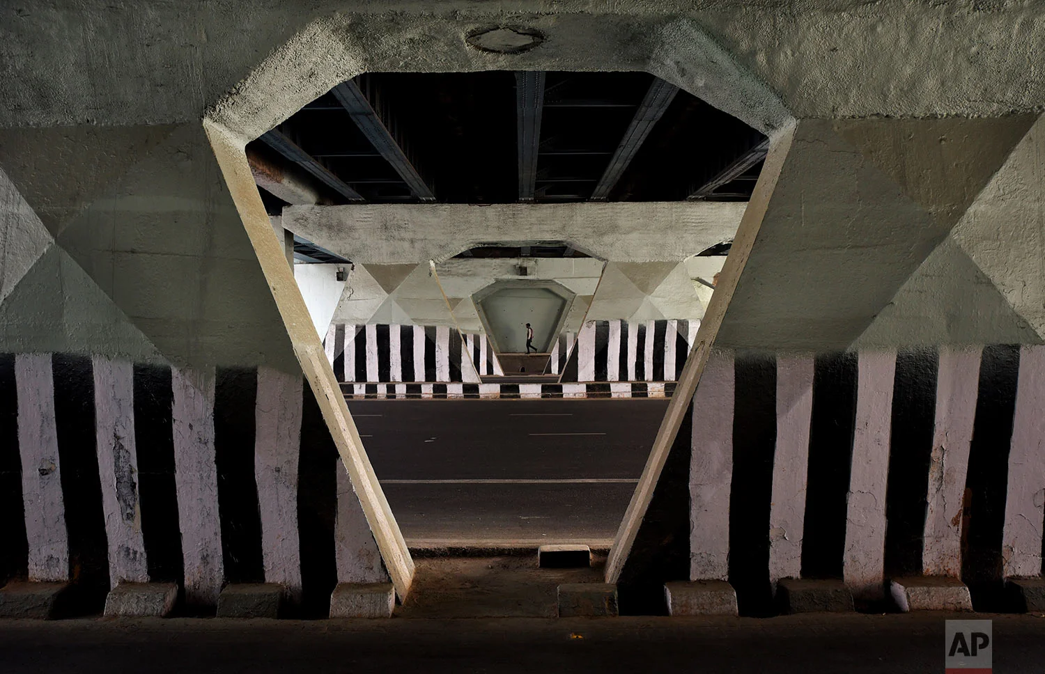 A man walks through an underpass in New Delhi, India, Wednesday, Nov.29, 2017. (AP Photo/R S Iyer)