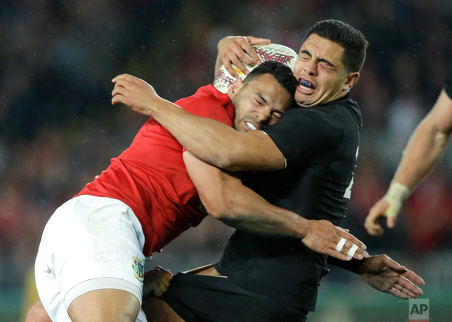 All Blacks centre Anton Linert-Brown, right, is tackled by British and Irish Lions Ben Te'o during the first test between the British and Irish Lions and the All Blacks at Eden Park in Auckland, New Zealand, Saturday, June 24, 2017. (AP Photo/Mark Baker)