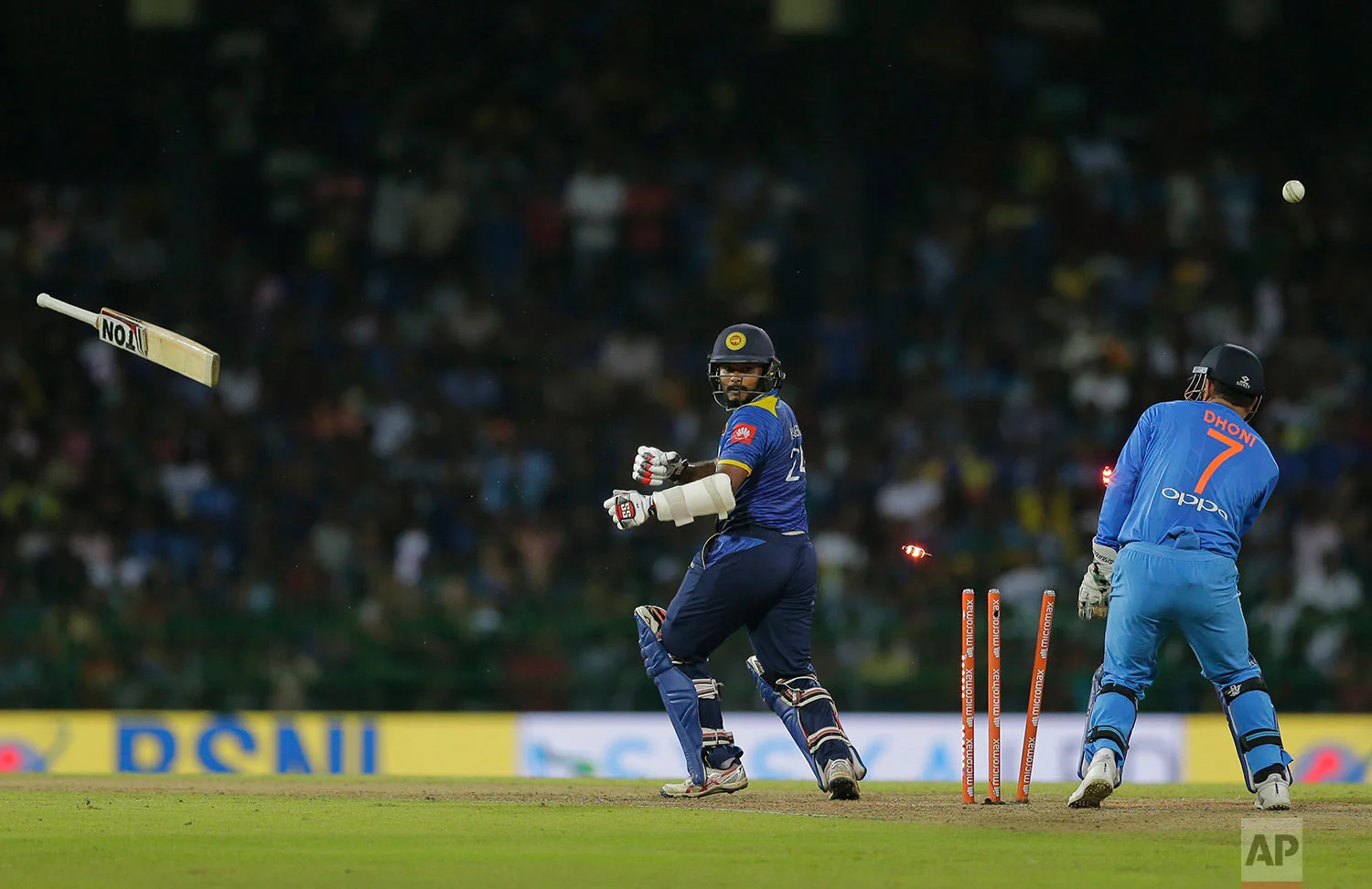 Sri Lanka's Dilshan Munaweera looses his bat as he is bowled by India's Kuldeep Yadav during their Twenty20 cricket match in Colombo, Sri Lanka, Wednesday, Sept. 6, 2017. (AP Photo/Eranga Jayawardena)