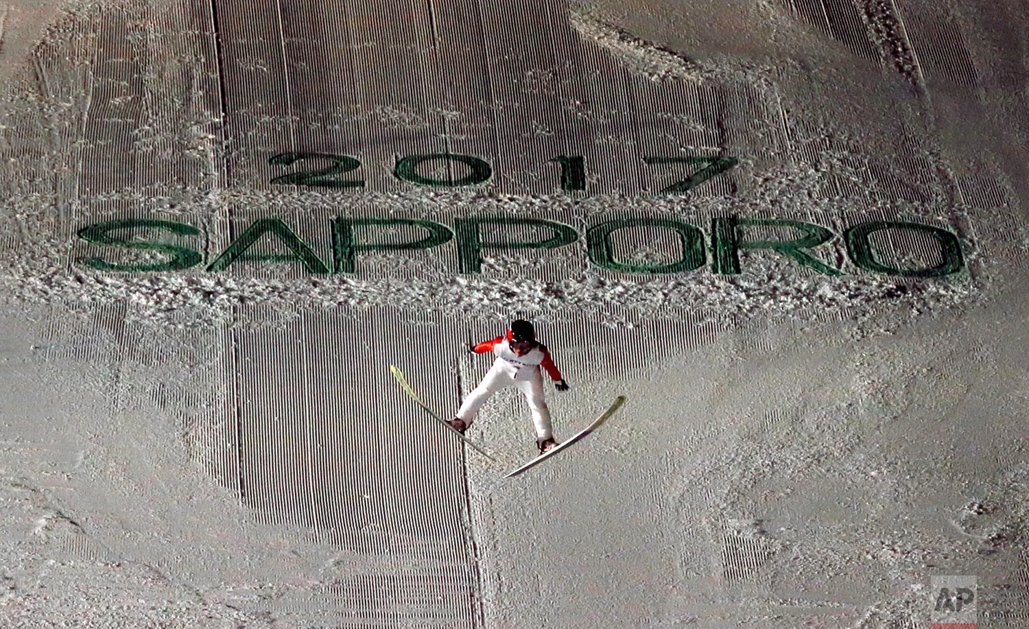 Japan's Naoki Nakamura soars through the air in his second round jump at the ski jumping men's large hill individual at the Asian Winter Games in Sapporo, northern Japan, Friday, Feb. 24, 2017.(AP Photo/Shuji Kajiyama)