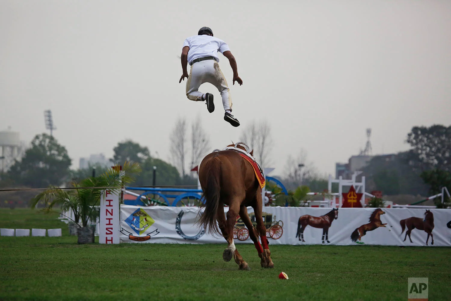 A Nepalese army soldier demonstrates his horse riding skills during the Ghode Jatra festival, an annual horse festival in Kathmandu, Nepal, Monday, March 27, 2017. According to legend, the festival is held to celebrate the victory over a demon named Tundi and people believe that the clamor of horses' hooves during the festival keeps the demon's spirit away. (AP Photo/Niranjan Shrestha)