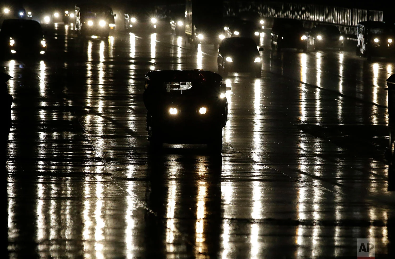 A passenger jeepney travels along a wet road during rains in metropolitan Manila, Philippines on Tuesday, Sept. 26, 2017.
Passenger jeepneys, often dubbed as the "King of the Road" in the Philippines now faces new challenges as the government will soon implement the Public Utility Vehicle modernization program which aims to rid them of their aging diesel engines and also add more safety modifications, including public wifi and on-board CCTV. The program will affect some 600,000 Filipino drivers in the country. (AP Photo/Aaron Favila)