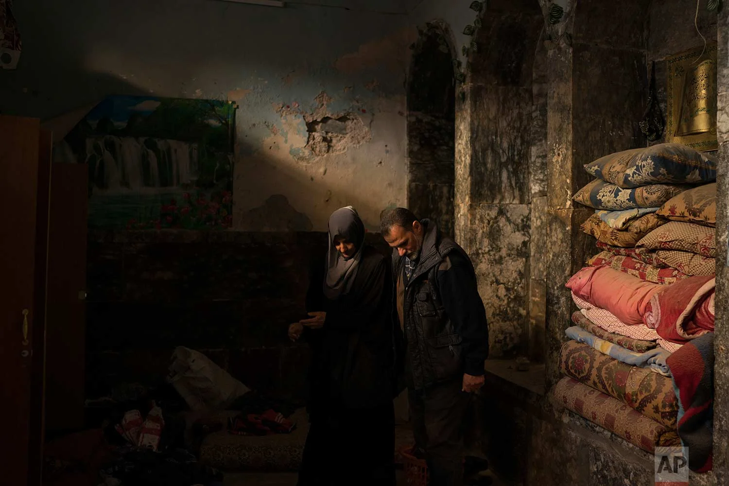 In this Nov. 16, 2017 photo, Yahya Ali, right and Haifa Shehab, look through the rubble in their house in the Old City of Mosul, Iraq. (AP Photo/Felipe Dana)