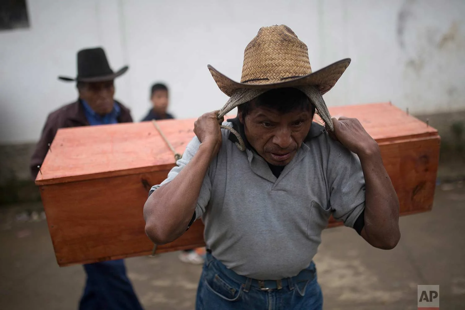 In this Nov. 30, 2017, an Ixil Mayan carries the remains of a civil war victim to a memorial for a mass burial in Santa Avelina, Guatemala. (AP Photo/Luis Soto)