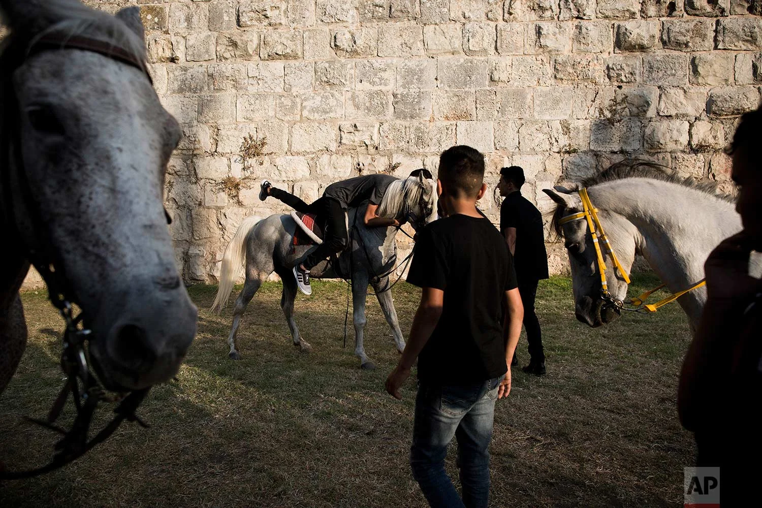 In this Tuesday, June 27, 2017 photo, Palestinians ride on horses during the Eid al-Fitr holiday outside Damascus Gate in Jerusalem. (AP Photo/Oded Balilty)