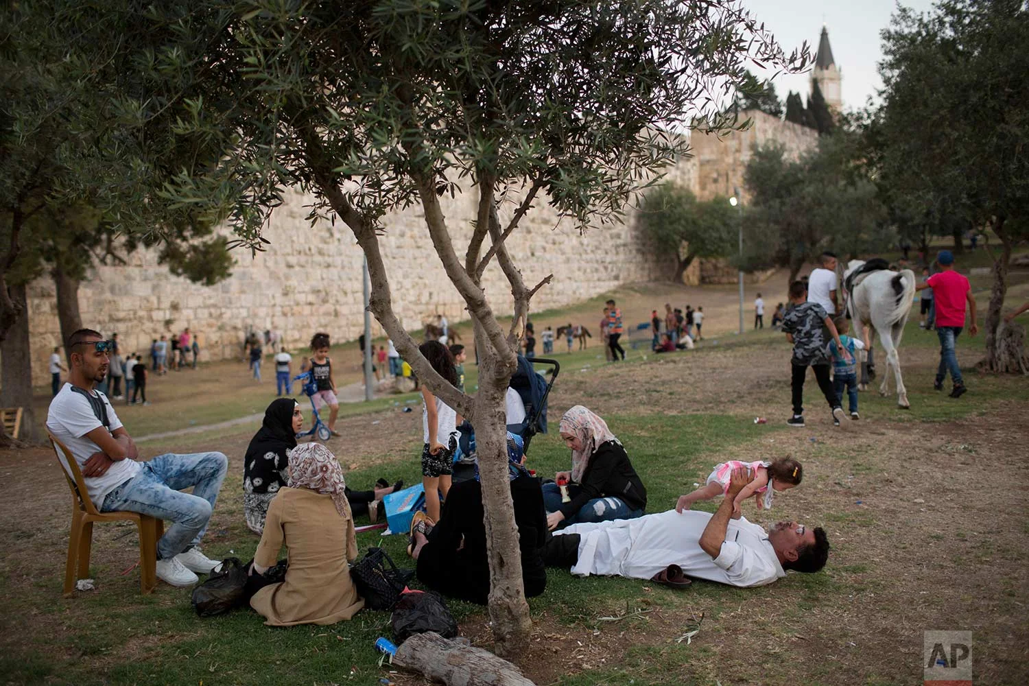In this Tuesday, June 27, 2017 photo, Palestinians celebrate the Eid al-Fitr holiday outside Damascus Gate in Jerusalem. (AP Photo/Oded Balilty)