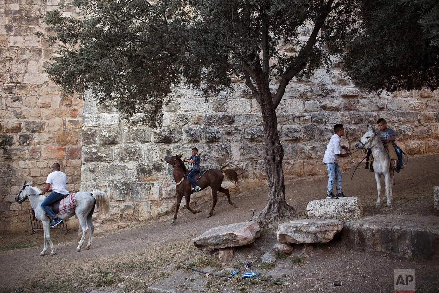 In this Tuesday, June 27, 2017 photo, Palestinians ride on horses during the Eid al-Fitr holiday outside Damascus Gate in Jerusalem. (AP Photo/Oded Balilty)