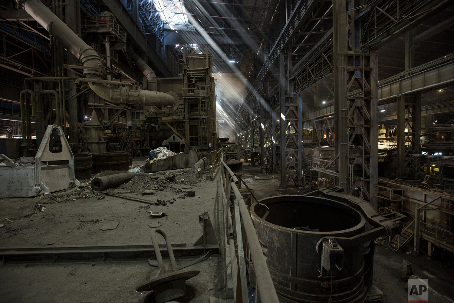  In this Nov. 7, 2017 photo, light rays enter through the windows of Sidor's Palanquilla steel plant, in Ciudad Guayana, Bolivar state, Venezuela. In 2008 President Hugo Chavez began putting these factories, then owned by conglomerates from Japan and