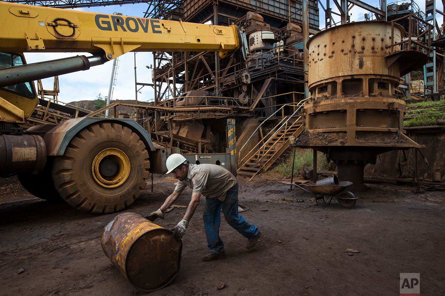  In this Nov. 2, 2017 photo, a Ferrominera Orinoco worker rolls a an empty barrel in Ciudad Piar, Bolivar state, Venezuela. Venezuela sits atop the world's largest oil reserves, but low crude prices and a plunge in production has left it in an econom