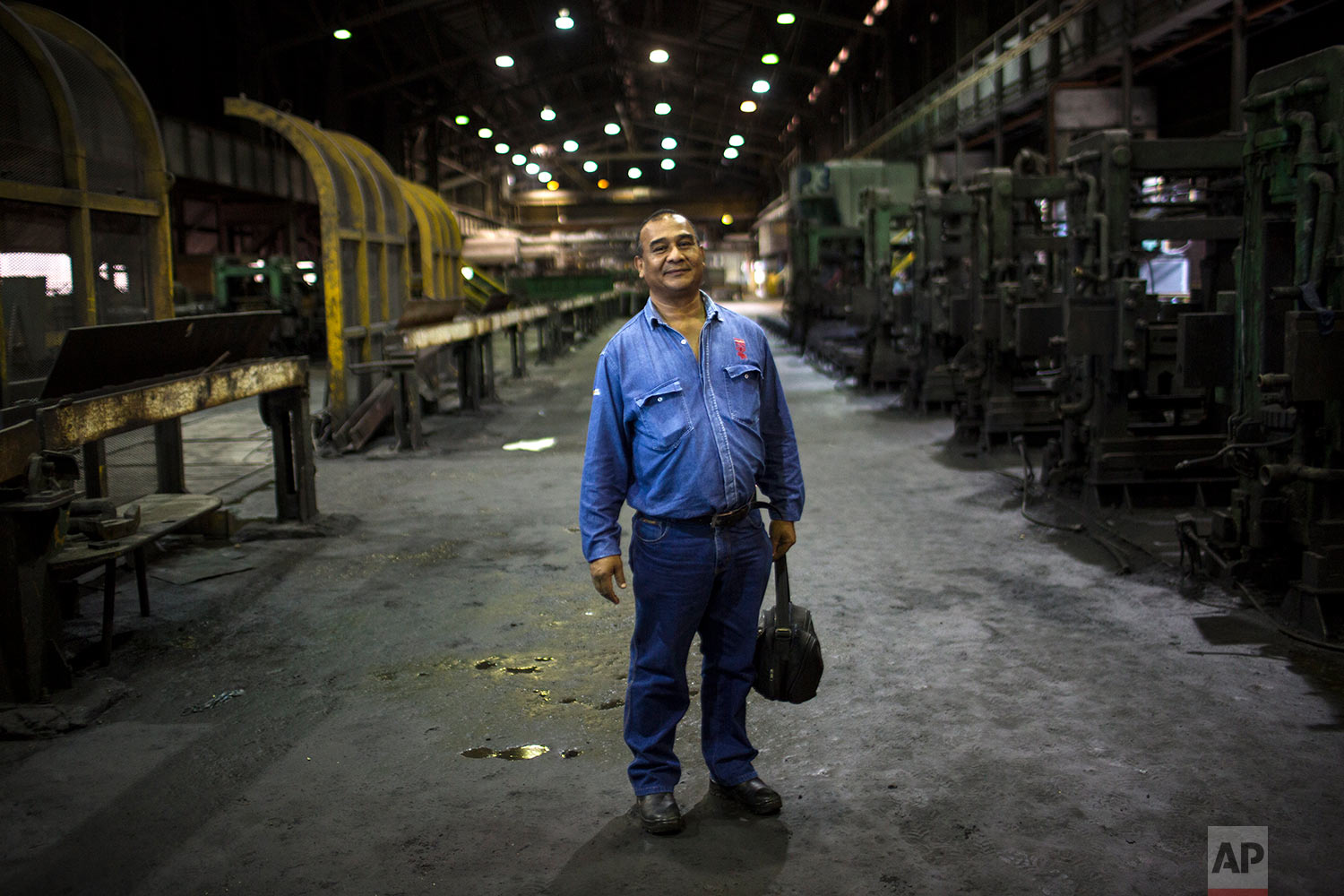  In this Nov. 7, 2017 photo, Cesar Brito poses for a picture inside Sidor's Alambron plant in Ciudad Guayana, Bolivar state, Venezuela. Brito has worked for Sidor for 33 years. (AP Photo/Rodrigo Abd) 